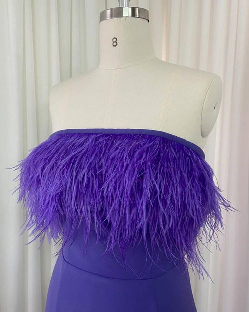 Long party dress with strapless neckline and feathers